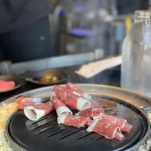 a close up of a bbq with meat on it