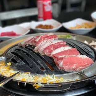 the meat being cooked on the grill