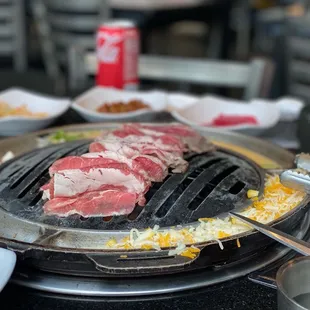 the meat being cooked on the grill