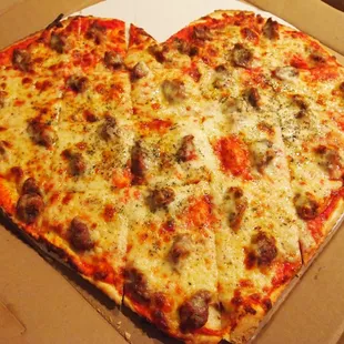 Heart-shaped sausage pizza for Valentine&apos;s Day