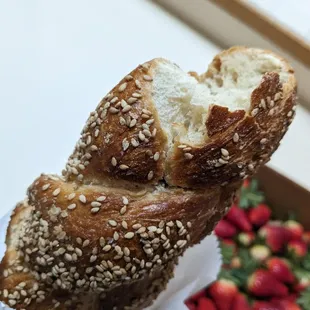 a hand holding a loaf of bread