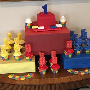 D&amp;D made the block cake on top and the red velvet cupcakes with white icing.  The cake was a hit and complemented our theme extremely well.