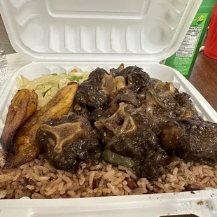 Oxtails dinner with cabbage and coconut rice and peas