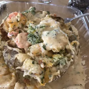 Shrimp stuffed potato with mixed veggies and cheese sauce.