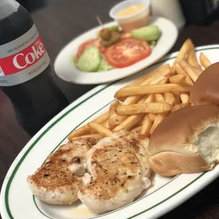 Grilled chicken plate with a salad and drink