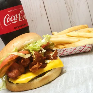 Bacon cheese burger with fries and a drink