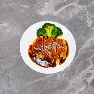 Teriyaki Chicken  Tender Chicken breast FireArt Teriyaki sauce garnish with broccoli and sesame.