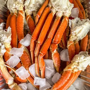 a bowl of crab legs with ice