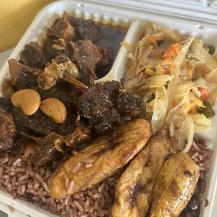 Oxtail, rice with peas, cabbage with carrots and plantains