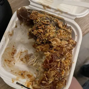 Half eaten shoyu ahi and spicy ahi bowl.