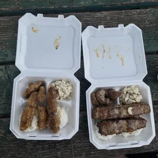 two trays of food on a picnic table