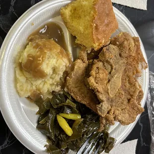 Pork chop, greens and mashed potatoes