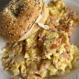 a bagel and scrambled eggs on a plate