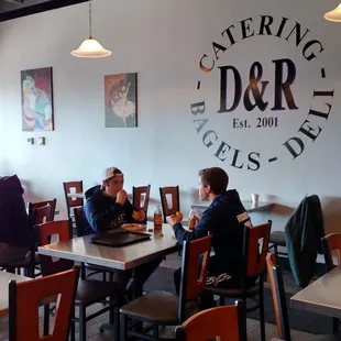 people sitting at tables in a restaurant