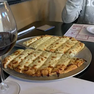 a person sitting at a table with a glass of wine