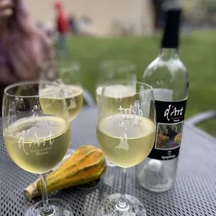 three glasses of white wine and a gourd