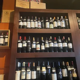 a shelf of wine bottles