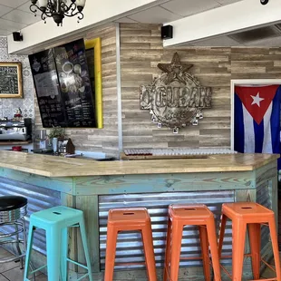 a bar with colorful stools