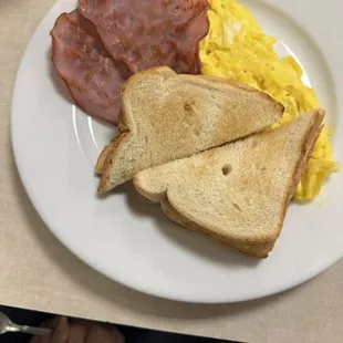 D'Favorite Two eggs scrambled with ham and white toast.