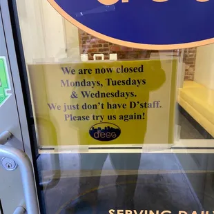 a woman standing in front of a closed sign