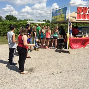 a group of people standing under a tent