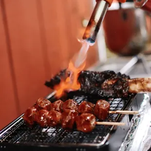  a person cooking meat on a grill