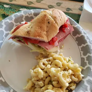 Half of the D&apos;Italia sub cut in half and macaroni salad. Both are 10 out of 10 amazing