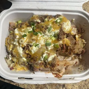 Stuffed loaded baked potato with chopped beef.