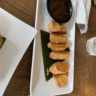 a plate of food and a bowl of dipping sauce