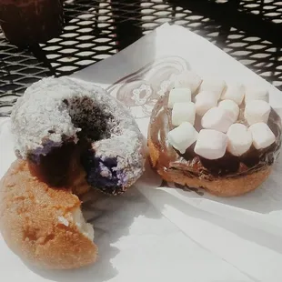 Ube doughnut with a plain doughnut and marshmallow chocolate.