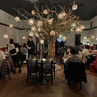 eople sitting at tables in a restaurant