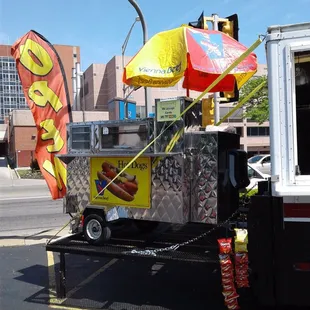 a hot dog cart on a city street
