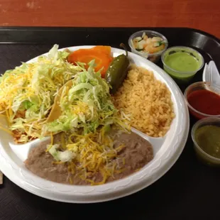 Shredded beef taco and enchilada plate and a sampling from the salsa bar.