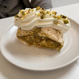 Meringue Roll with pistachio cream and almonds
