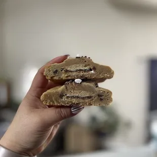 a hand holding a cookie