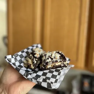 a hand holding a piece of cake