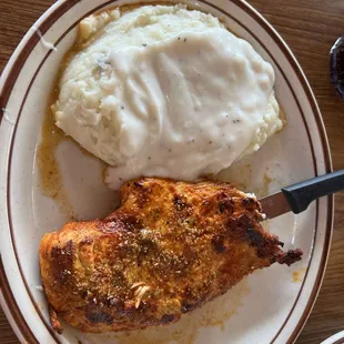 Grilled chicken. Breast with mashed potatoes and gravy