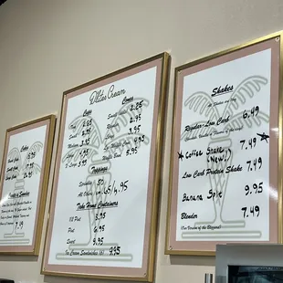 three framed menus on a wall