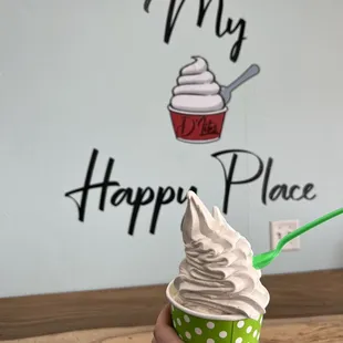 a person holding a cup of ice cream