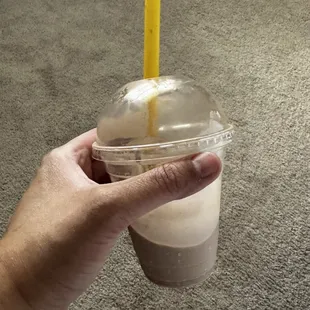 a hand holding a cup of coffee