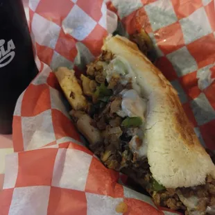 My cheesesteak on D'Lorenzo's fresh baked bread with fried onions, mushrooms, green peppers, lettuce and tomato. Excellent.