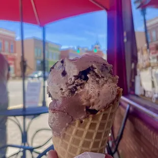 a person holding an ice cream cone