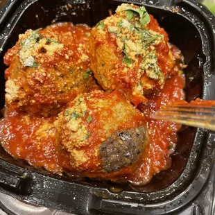 The meatball that is two different. I scraped of the sauce and the dark half was rock hard and dry the other half I  was able to cut .