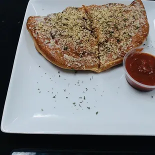 a slice of pizza on a plate with sauce