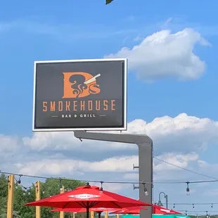 a sign and umbrellas