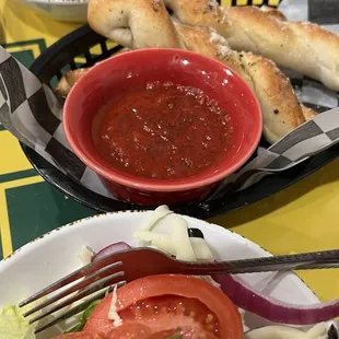 Bread sticks with marinara, Italian salad which we split.