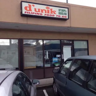 two cars parked in front of the store