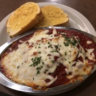 a dish of lasagna and bread
