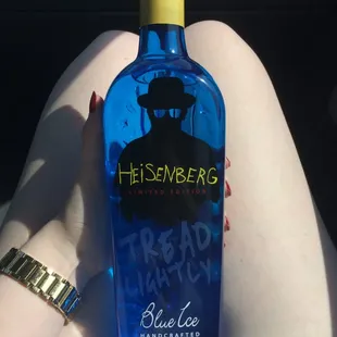 a woman holding a blue bottle