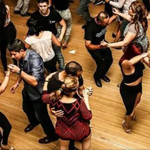 a group of people dancing in a dance studio